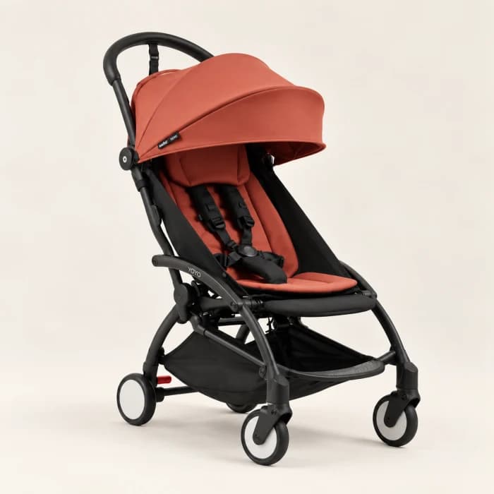 A compact baby stroller on a light background.