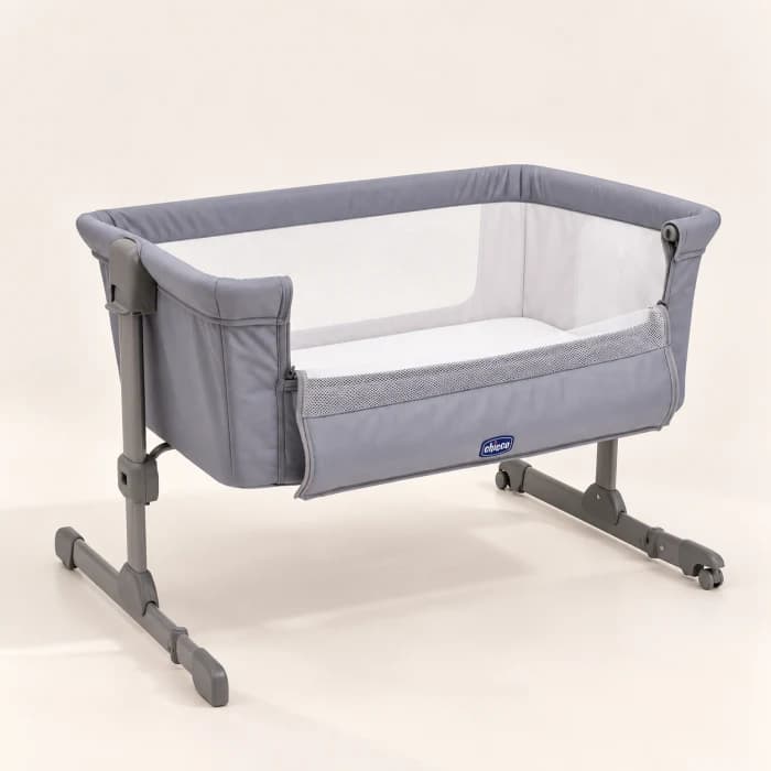 A bedside baby crib on a light background.
